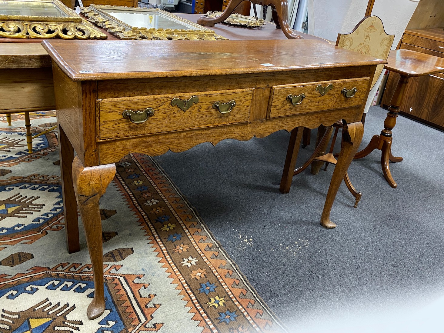 A mid 18th century style two drawer oak dresser base, width 121cm, depth 39cm, height 83cm